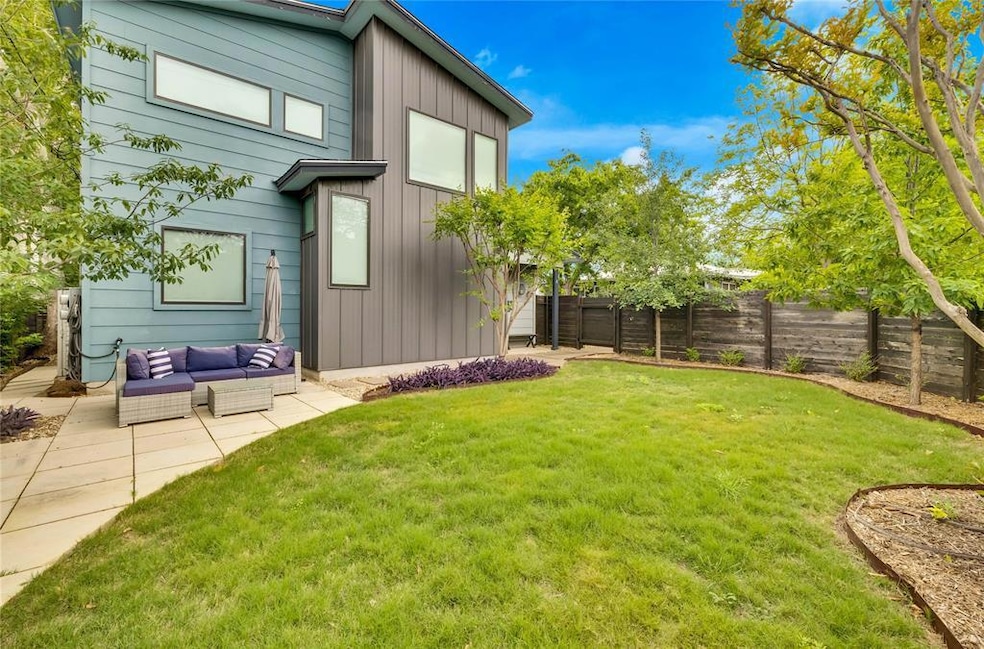 Fenced backyard with an outdoor hangout area and 