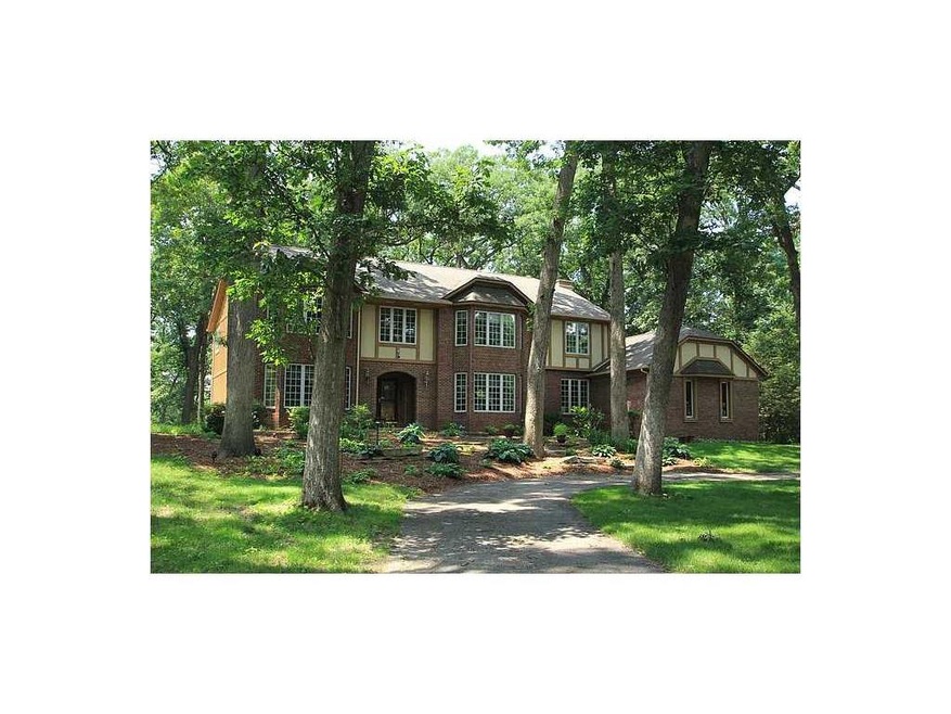 Front Exterior. Wooded corner lot with circular dr