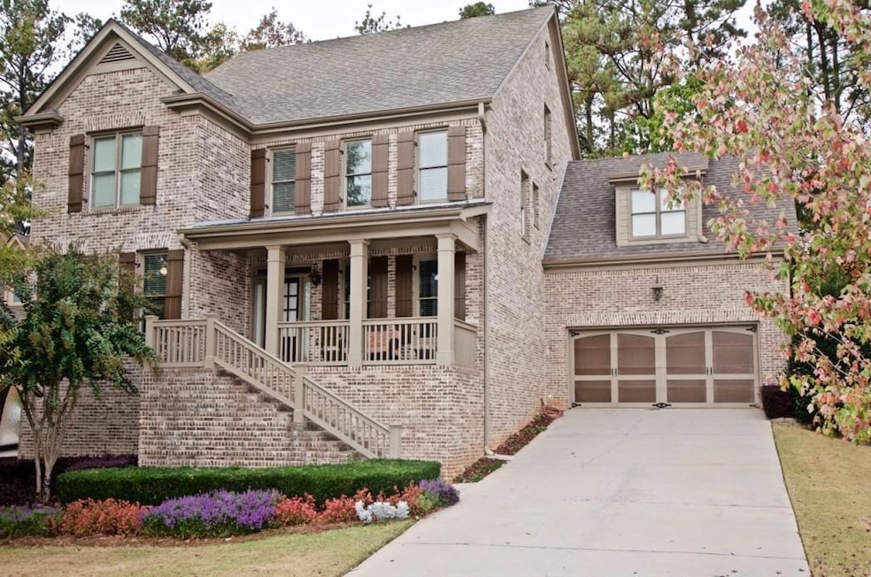View of front of house featuring a porch and a garage