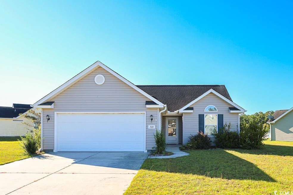 Ranch-style house featuring a front lawn, concrete driveway, and an attached garage