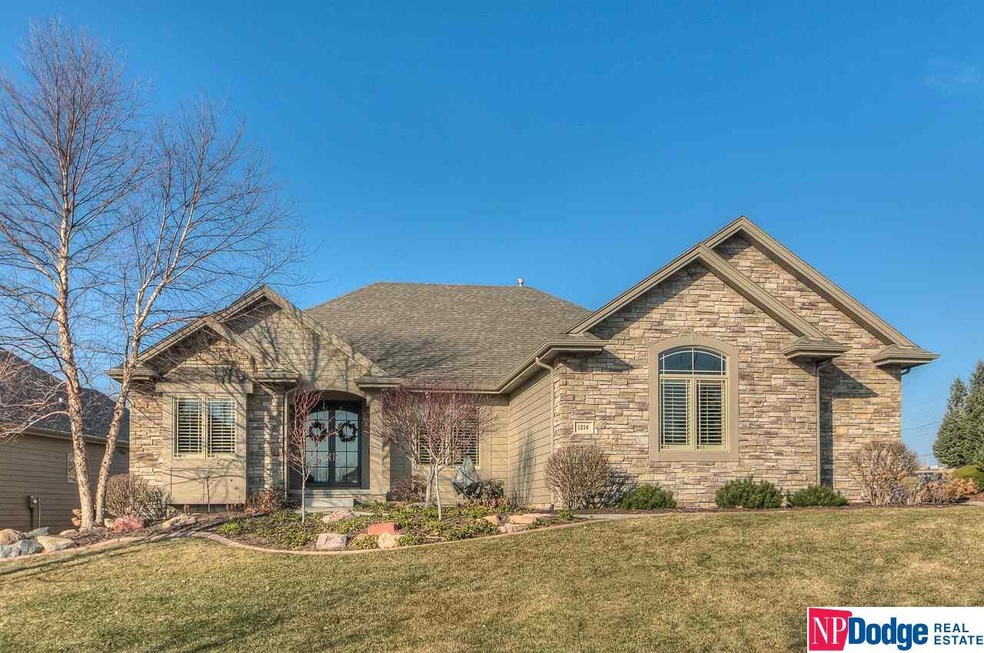 Blended elements of wood, shingles and natural stone enhance street appeal, and integrate the home with its lovely landscaping.