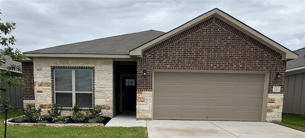 Single story home featuring stone siding, an attac