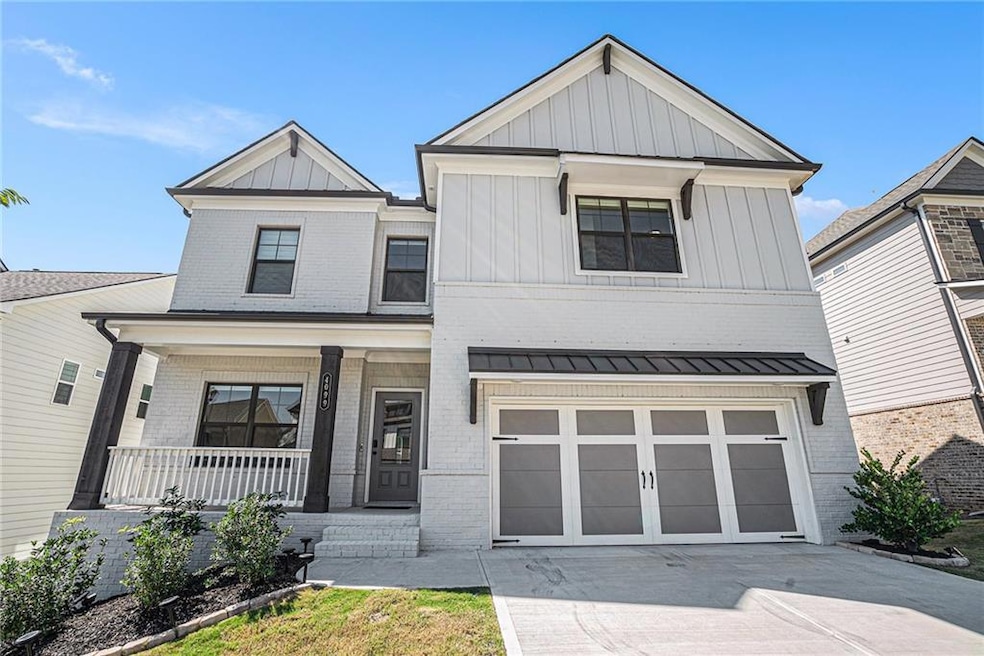 View of front of house with a garage and covered p