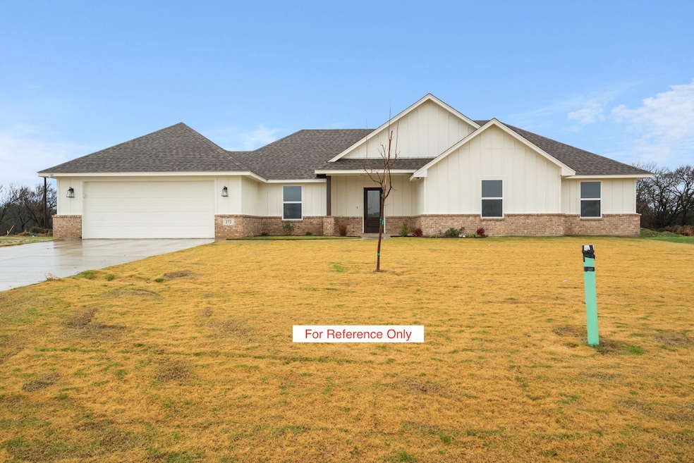 View of front facade featuring a front yard, driveway, and roof with shingles