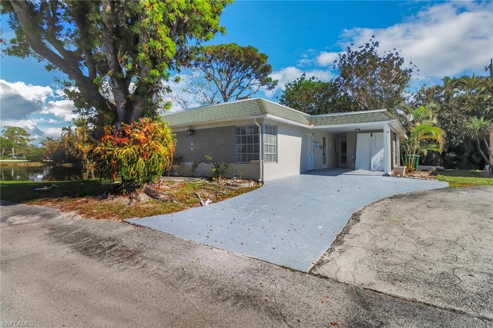 Single story home with a water view and a carport