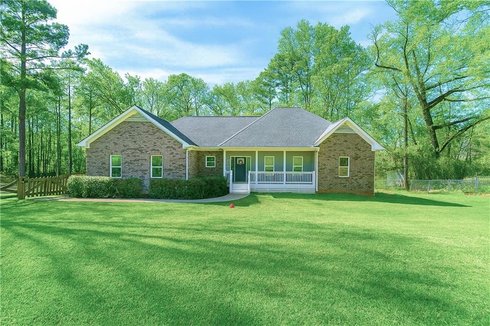 Single story home featuring a porch and brick siding