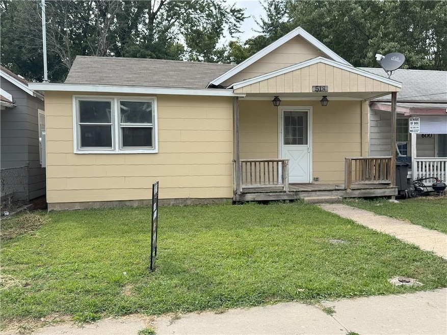 Bungalow featuring a porch, a front lawn, and roof with shingles