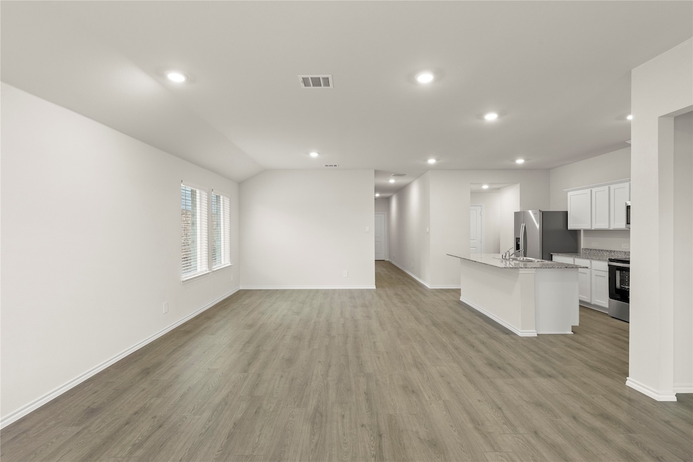 Unfurnished living room featuring recessed lighting and light wood-style floors