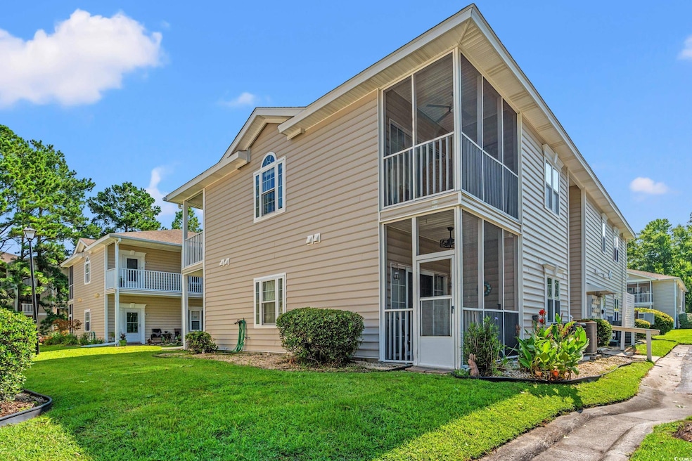 Back of property featuring a sunroom and a lawn