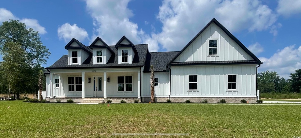 View of front of property with a front lawn and co