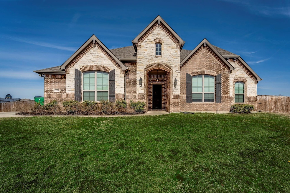 French provincial home with a shingled roof, brick
