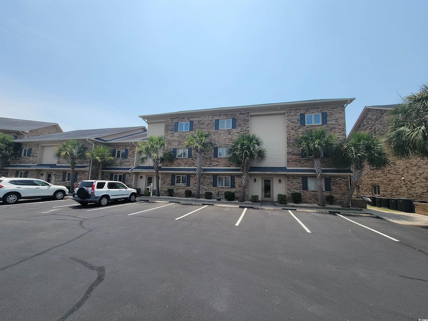 View of property featuring uncovered parking