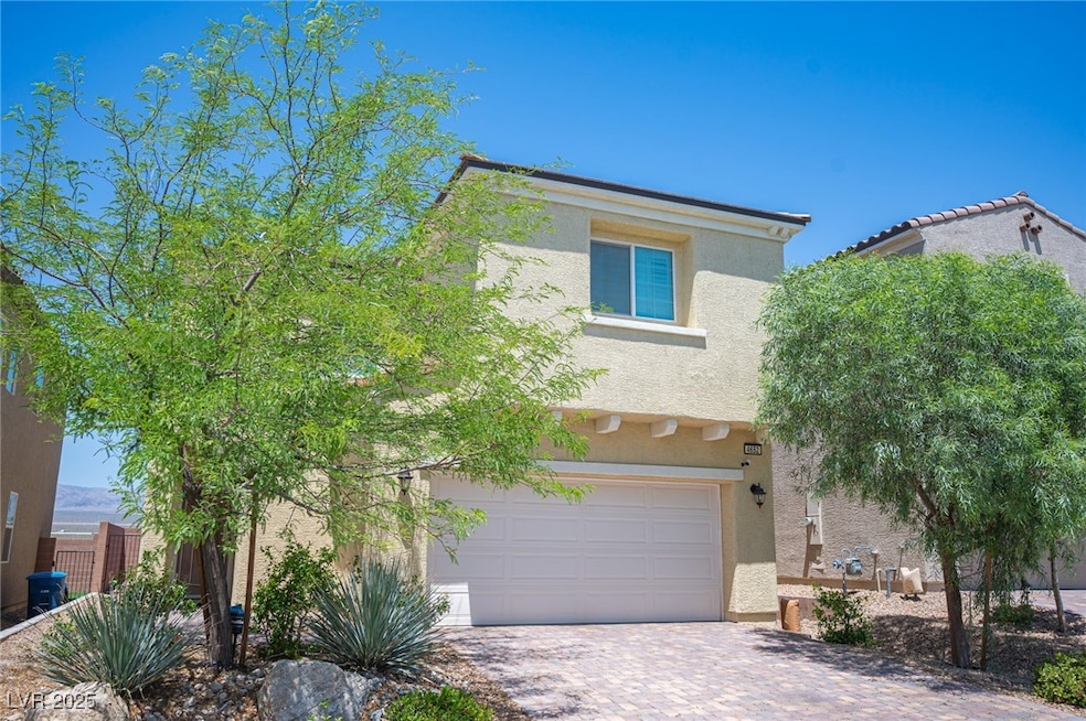 View of front of property with stucco siding, driv