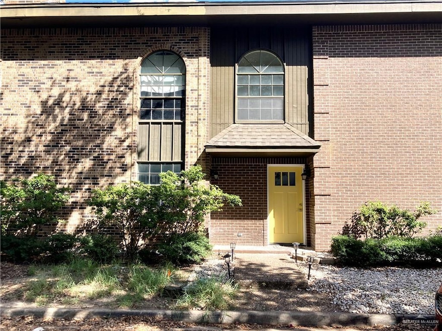 View of exterior entry featuring brick siding