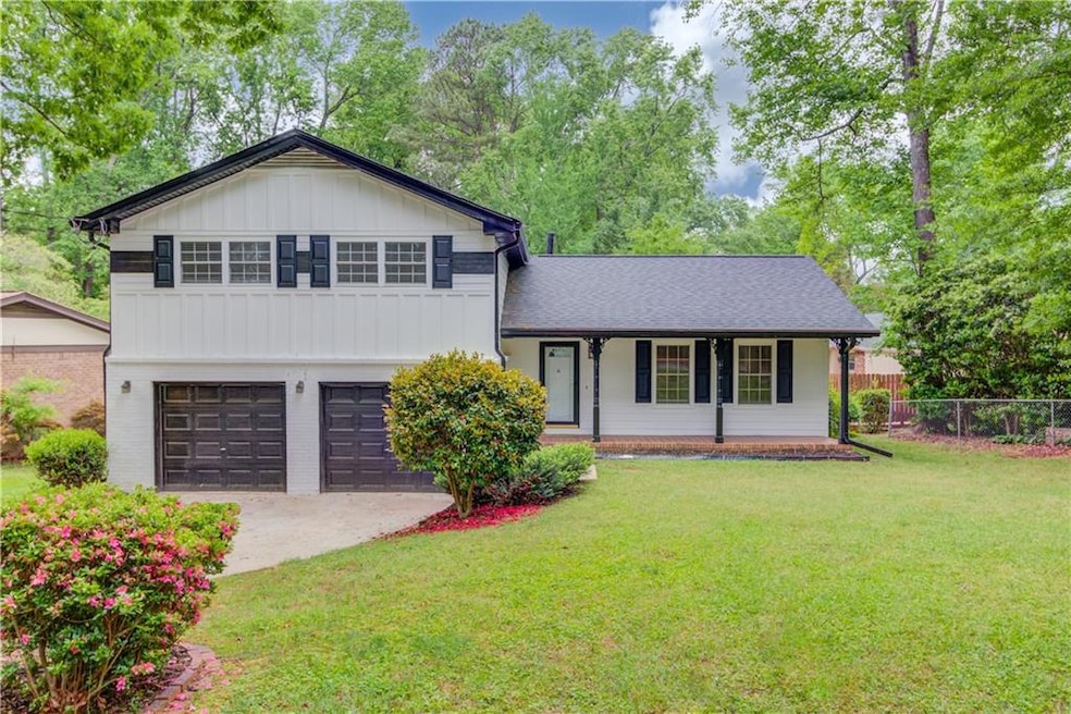 Tri-level home with driveway, board and batten sid