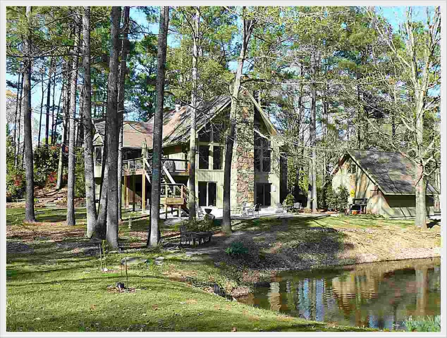 Gorgeous home on 4.91 wood acres. Stocked lake at 