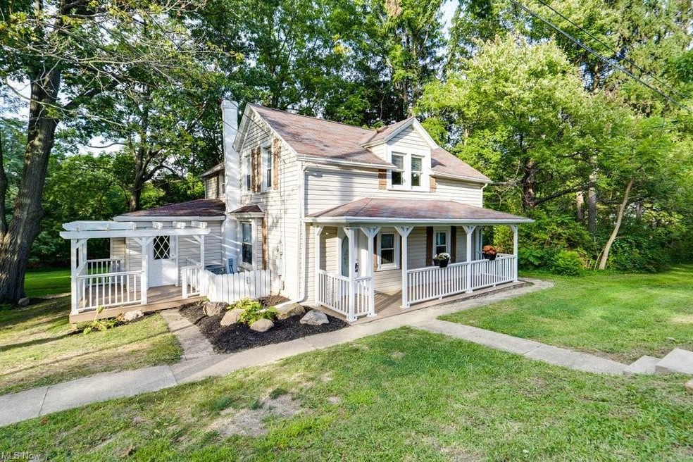 Farmhouse inspired home with a porch and a front l