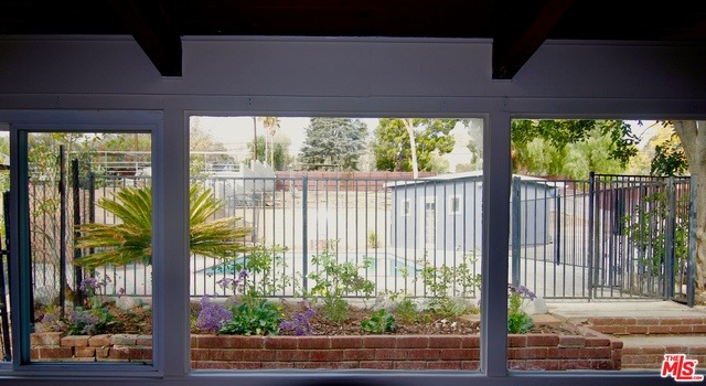 View of pool & paddock area from Family Room - Sun