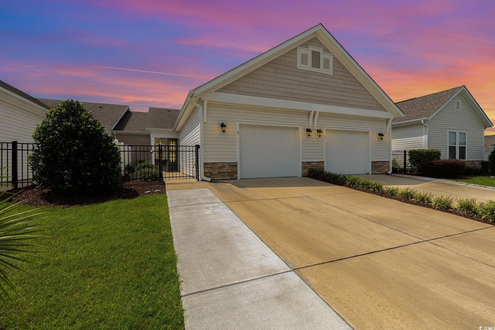 View of front facade featuring a yard and a garage