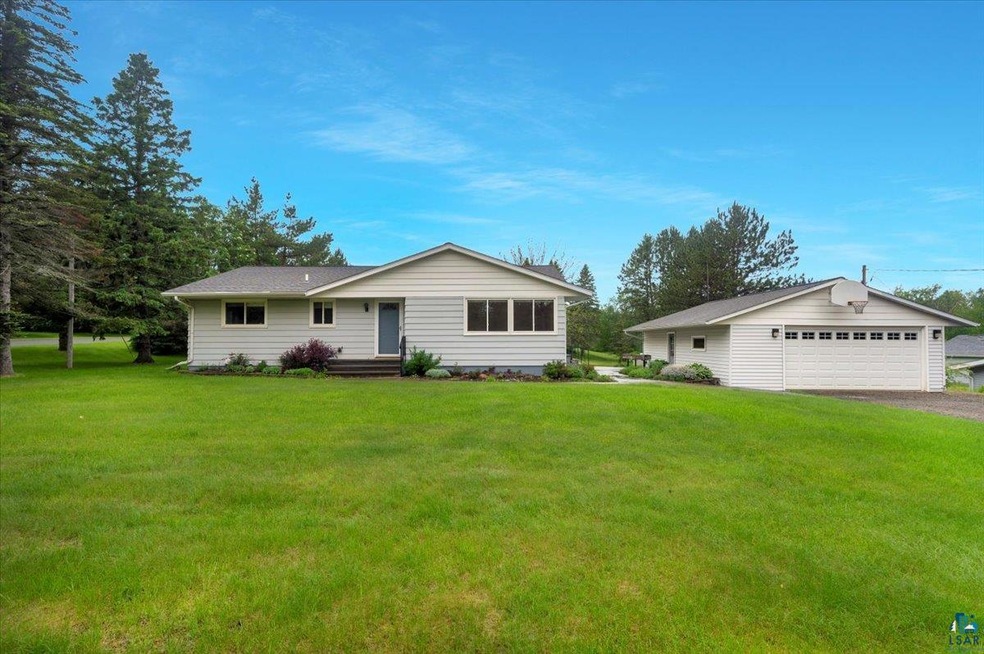 Ranch-style home featuring a garage and a front ya
