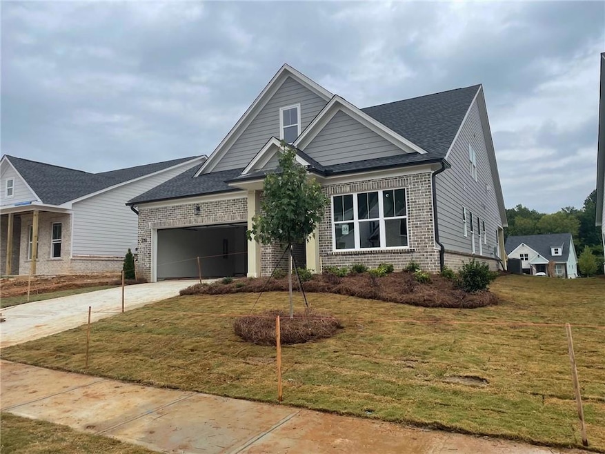 Craftsman-style house with a garage and lawnscaped