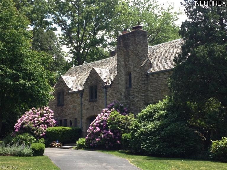 Welcome home to this stately stone English Tudor