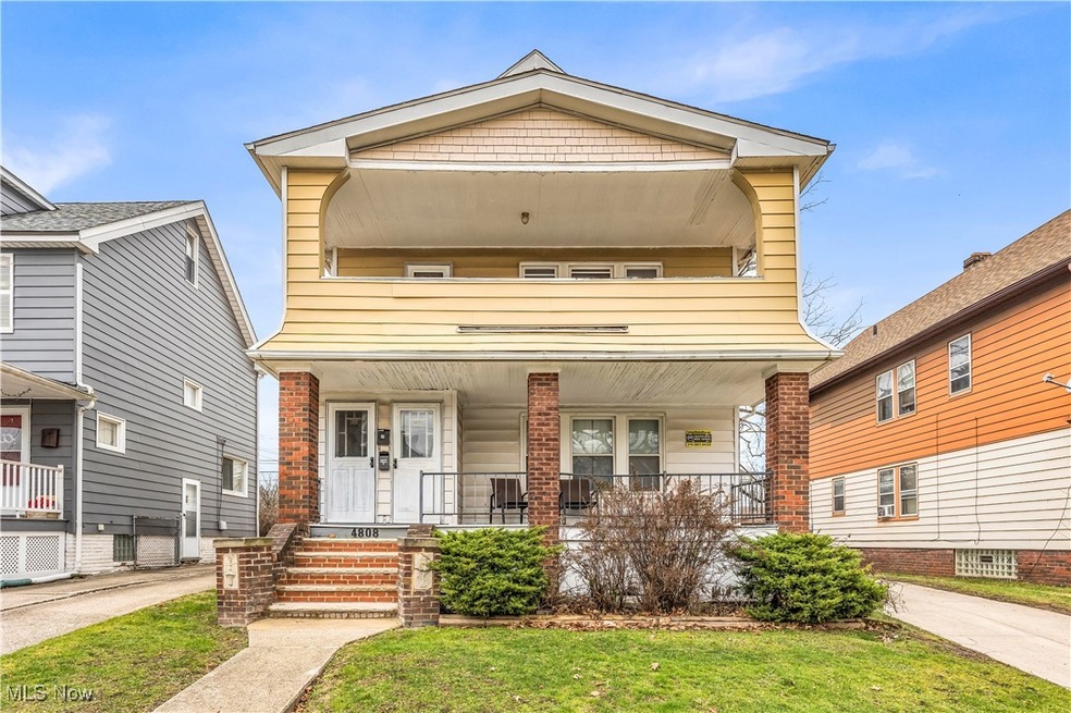View of front of property with a front yard and a porch