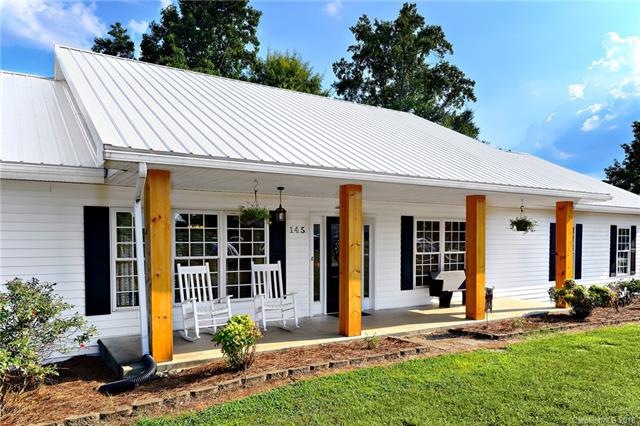 Enjoy relaxing on your rustic, covered rocking cha
