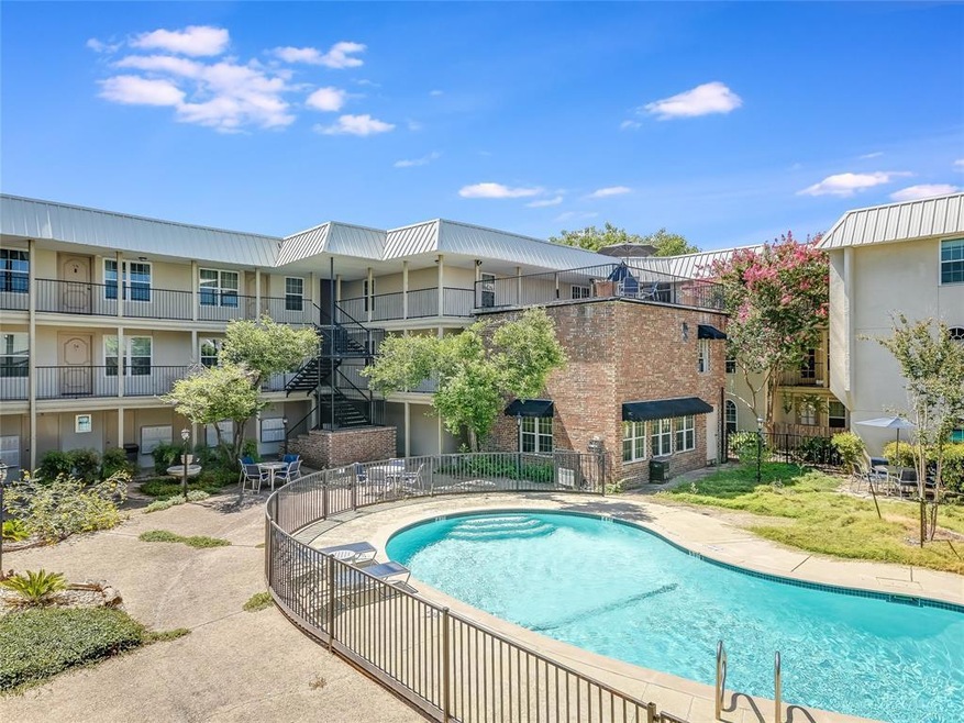 Community pool featuring stairs and a patio area
