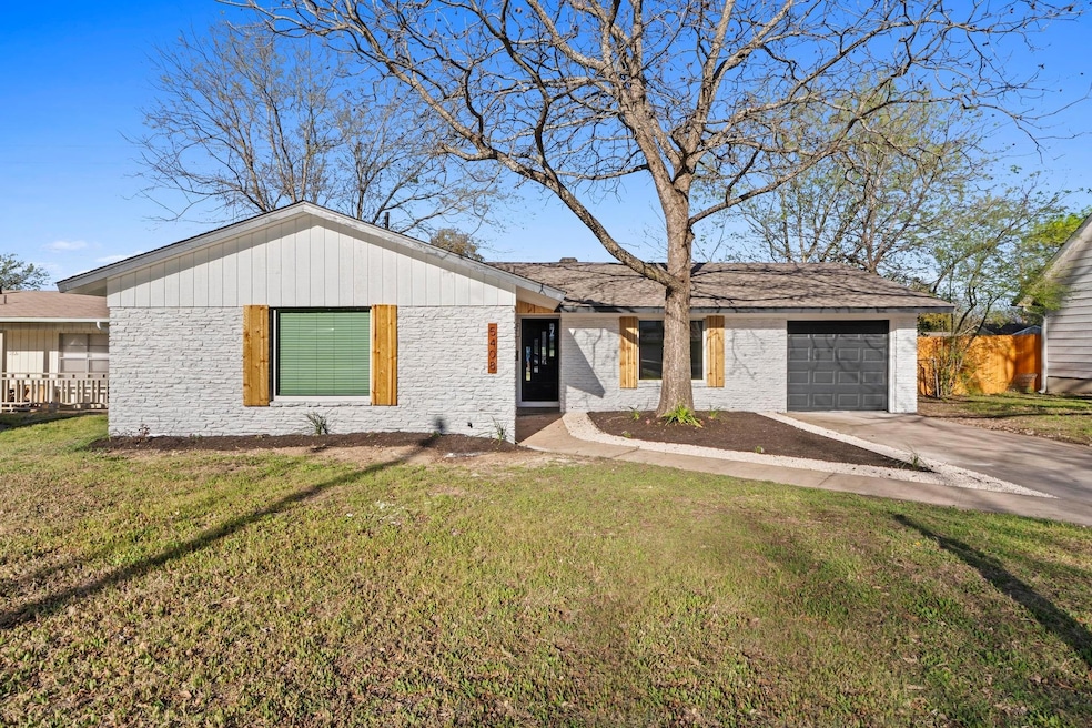 Ranch-style home featuring a garage, driveway, a 