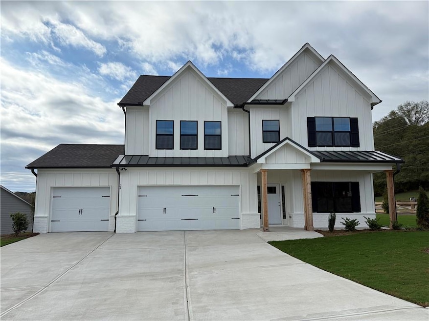 Modern inspired farmhouse featuring a garage and a