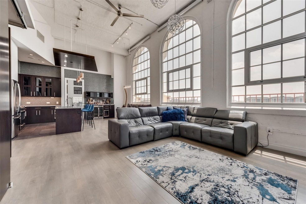 Living room featuring a towering ceiling, light ha