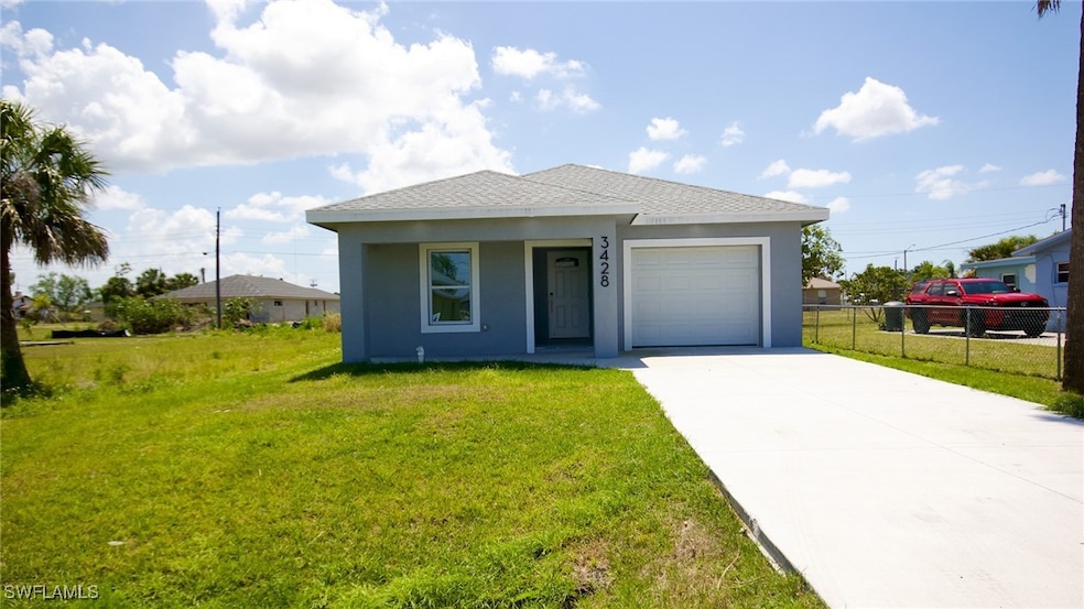 View of front of home featuring fence, an attached