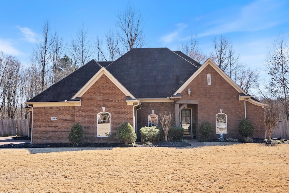 View of front of home with brick siding and fence