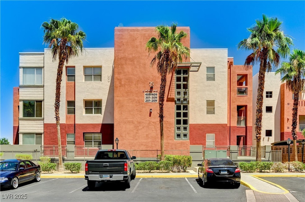View of building exterior with uncovered parking