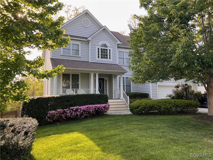 View of front of property with a garage, covered p