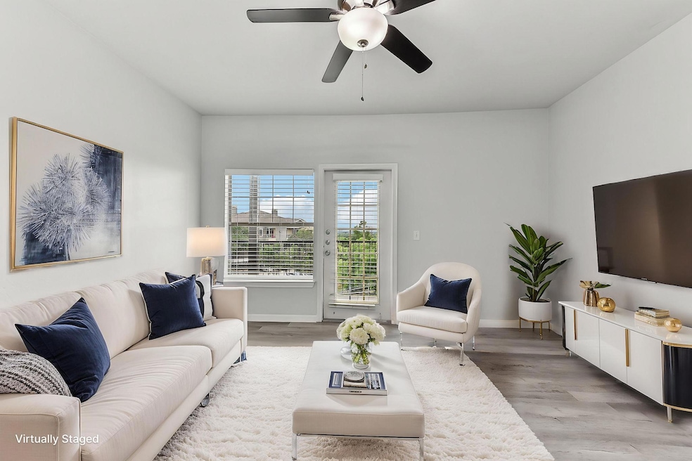 Living room with baseboards, light wood-style flo