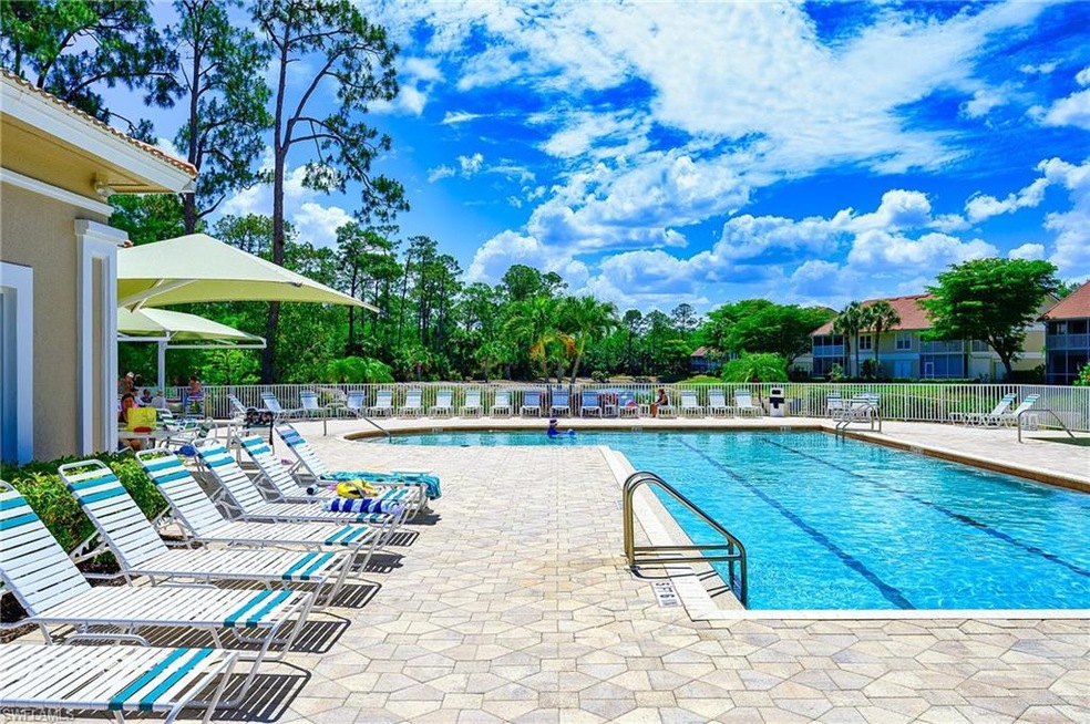 Community pool with fence and a patio area