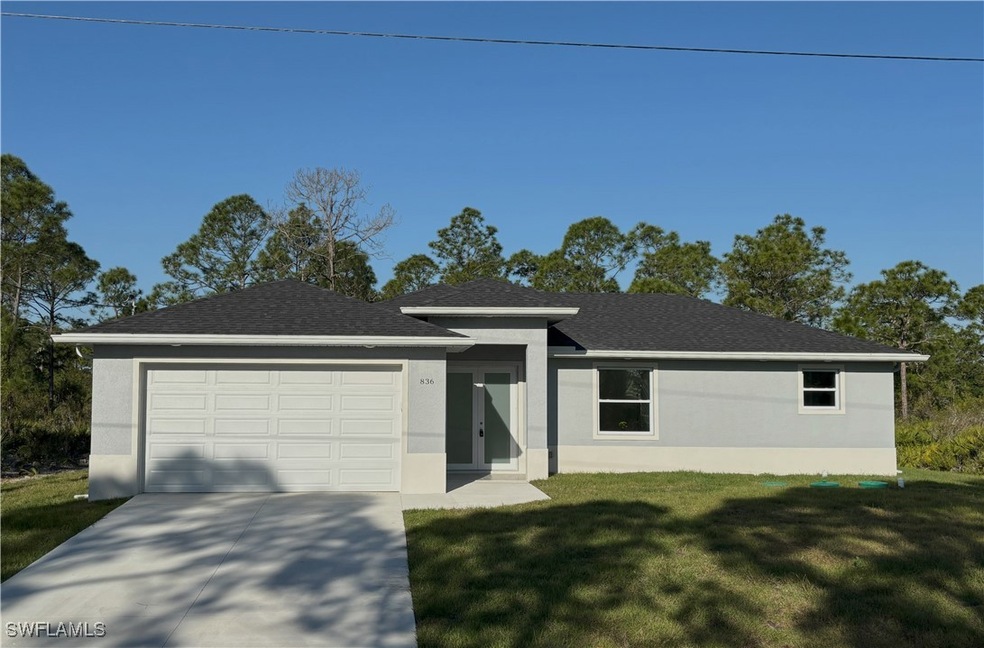 View of front of house with stucco siding, an atta