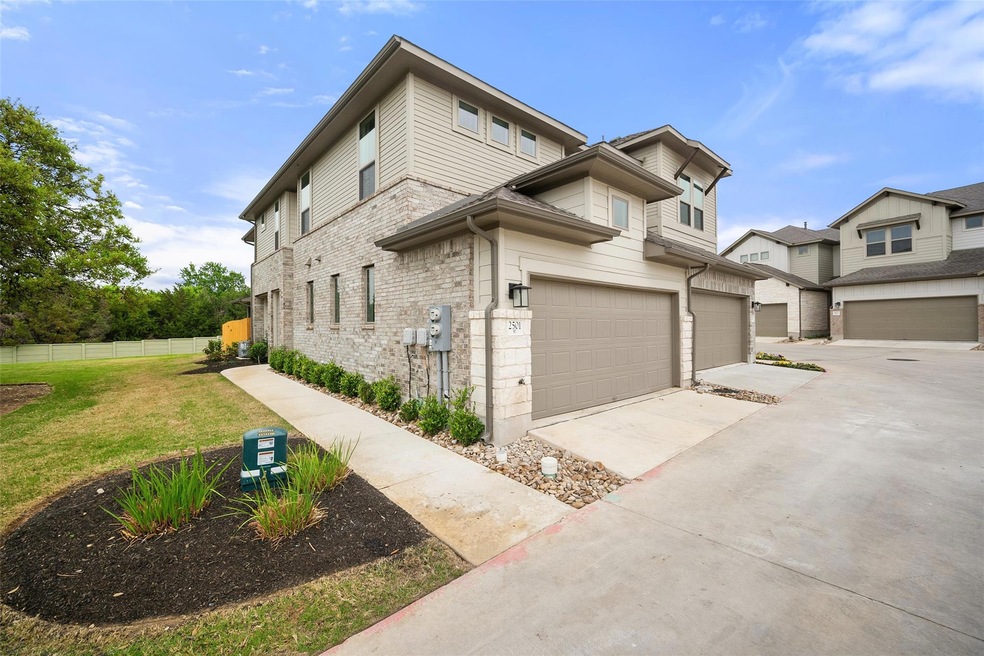 View of property exterior with driveway, an attac