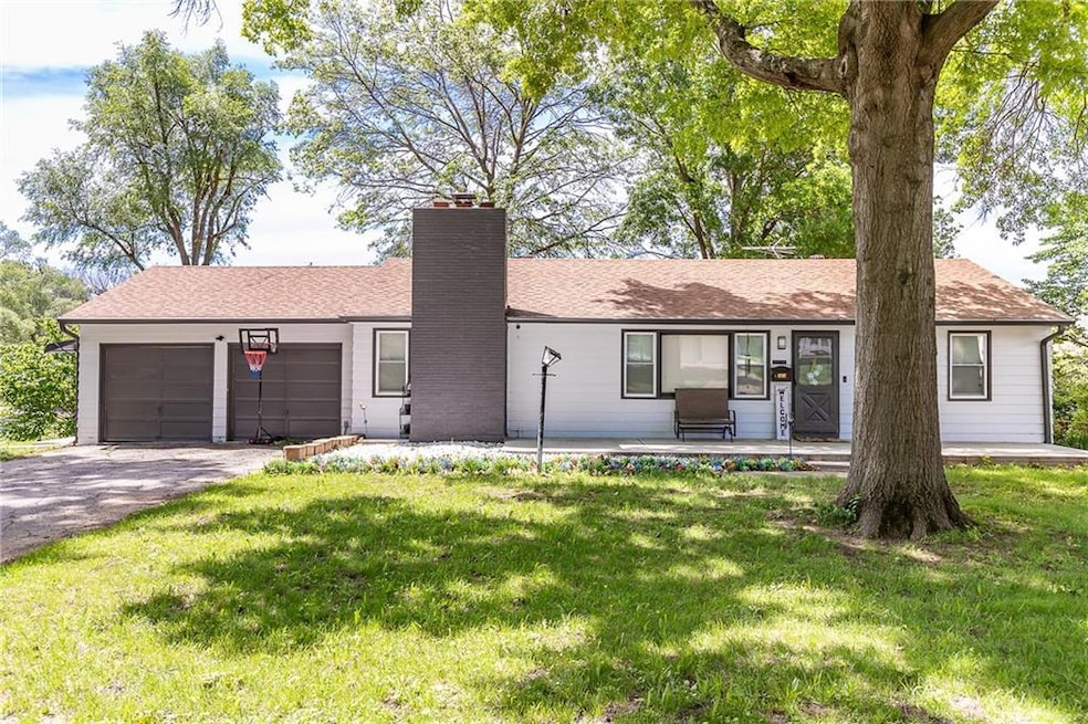 Ranch-style home featuring a garage and a front yard
