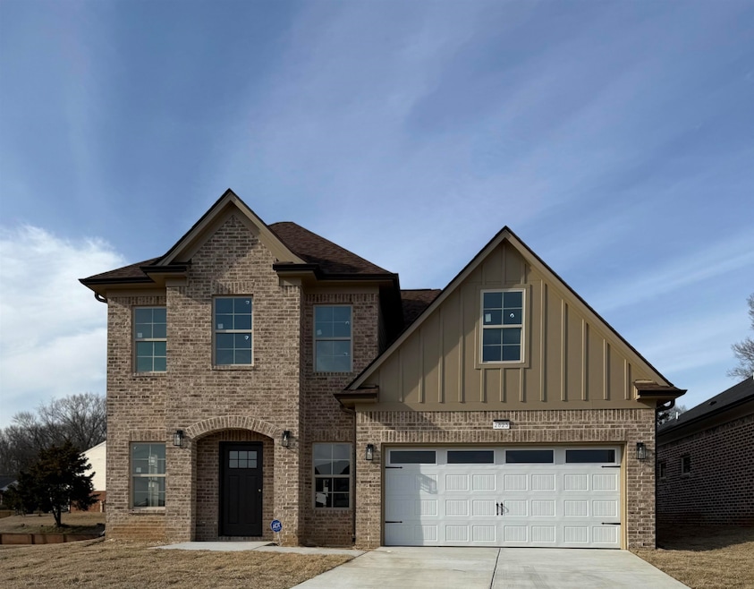 View of front of home with brick siding, board and