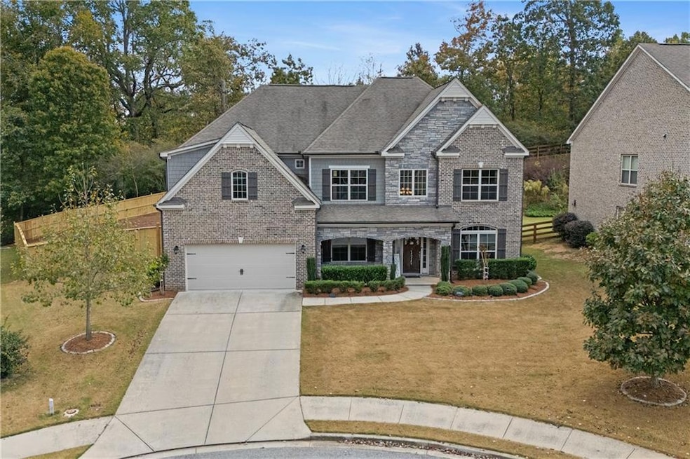 View of front of house featuring covered porch, concrete driveway, brick siding, an attached garage, and a shingled roof