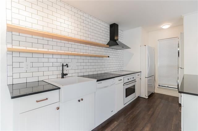 Beautifully updated and modern kitchen. White subway tiles, floating shelves and farmhouse sink all add to the charm of this kitchen.
