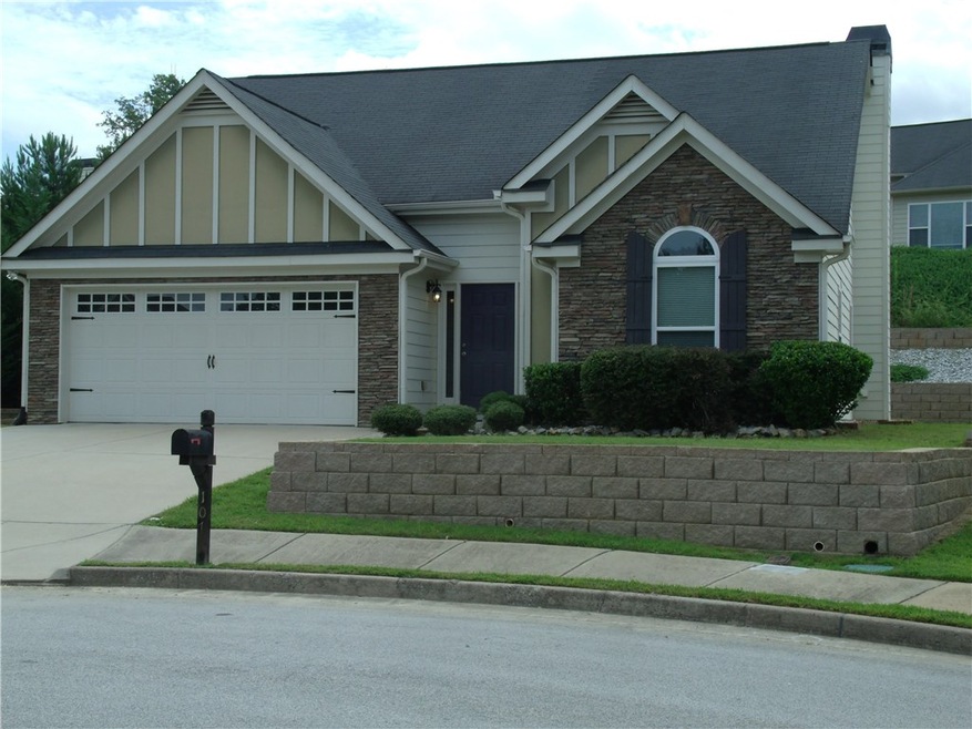 Front yard with professionally installed rock wall