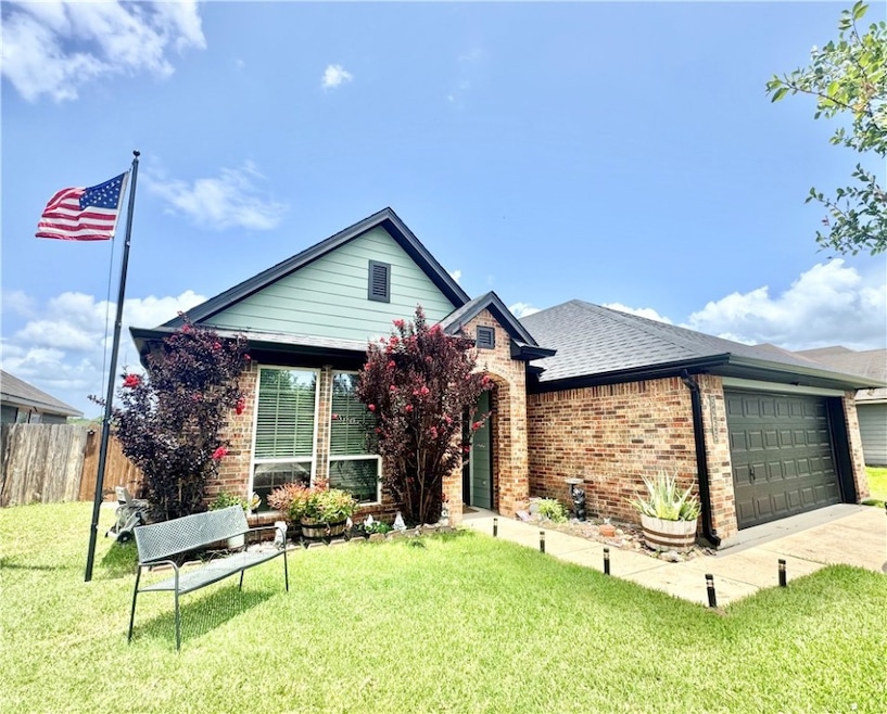 View of front of home with brick siding, an attach