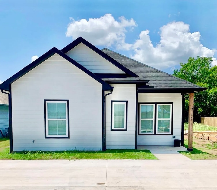Rear view of property with roof with shingles