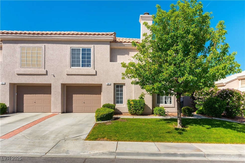 View of front of property with driveway, stucco si