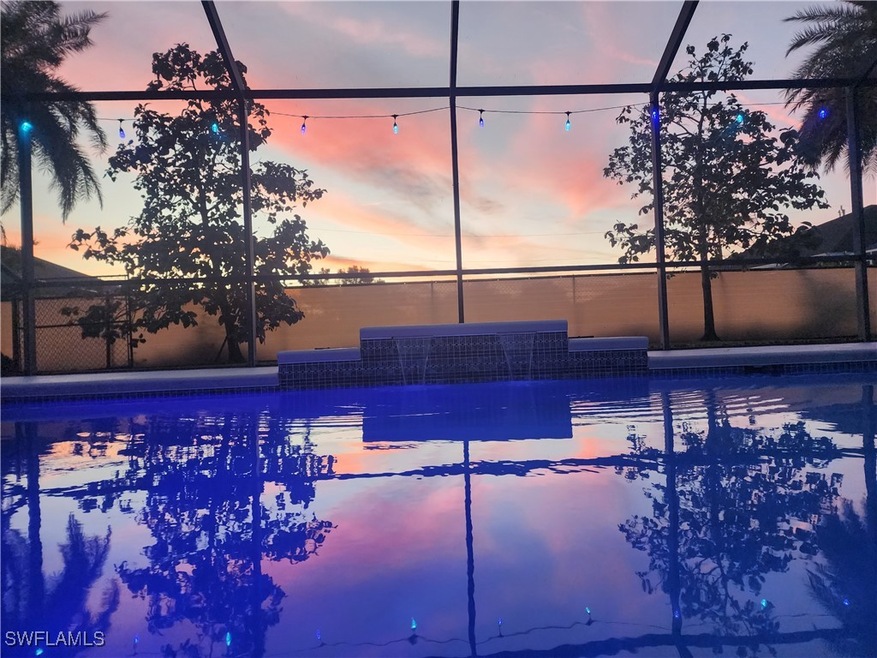 Pool at dusk featuring pool and screen enclosure