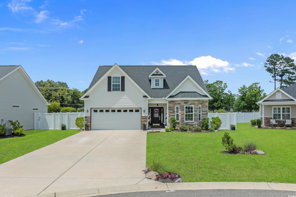 View of front of house featuring stone siding, concrete driveway, an attached garage, and a shingled roof
